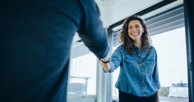 HR Manager shaking hands with coworker after meeting