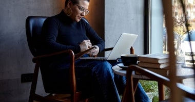 Psychology student studying on his laptop